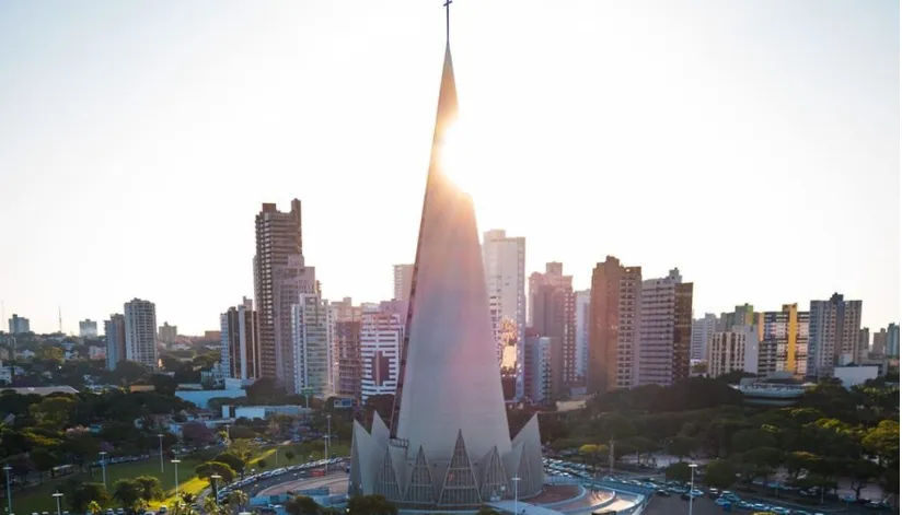A foto mostra a Catedral de Maringá, com o sol posicionado atrás.